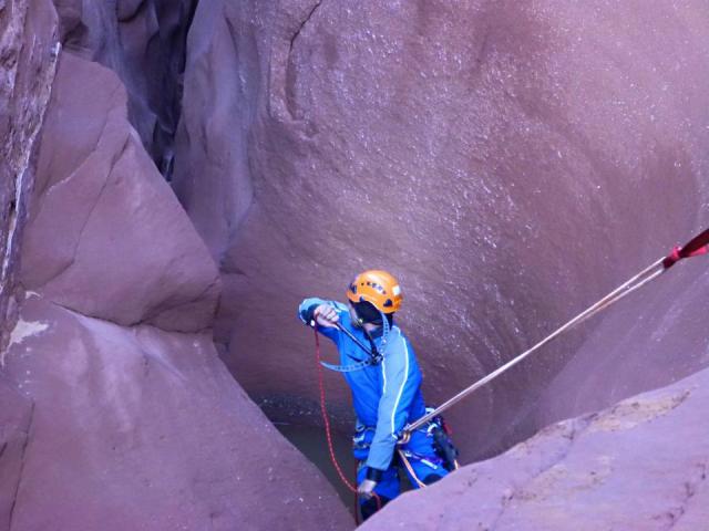 Damian using his grappling hook to avoid a pool