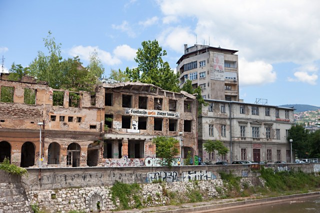 Some buildings have been repaired, but many wrecks still stand.